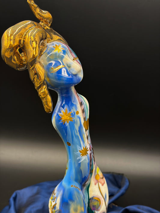 Decorative object with blue and gold design on a dark background