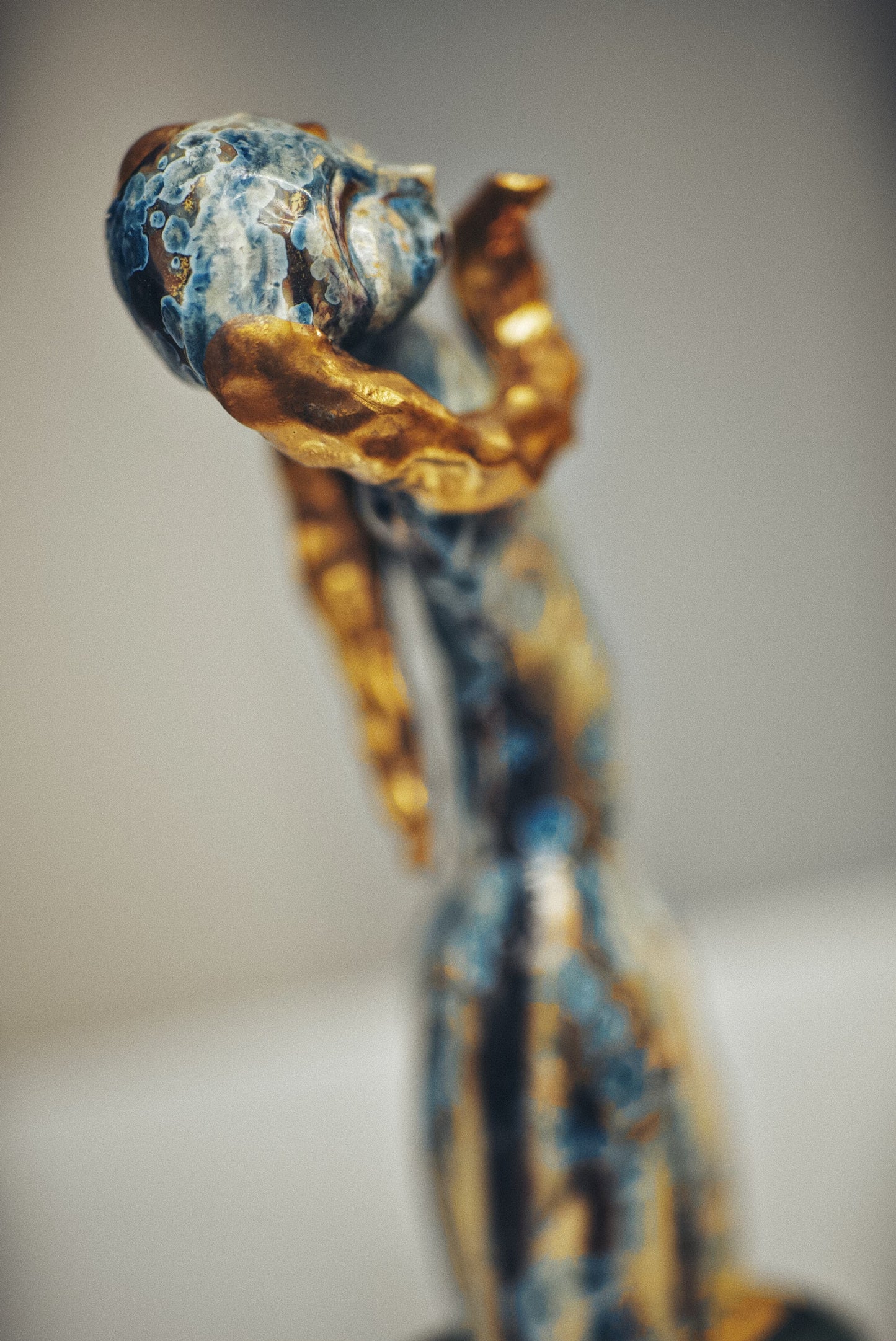 Decorative item with blue and gold design on a blurred background