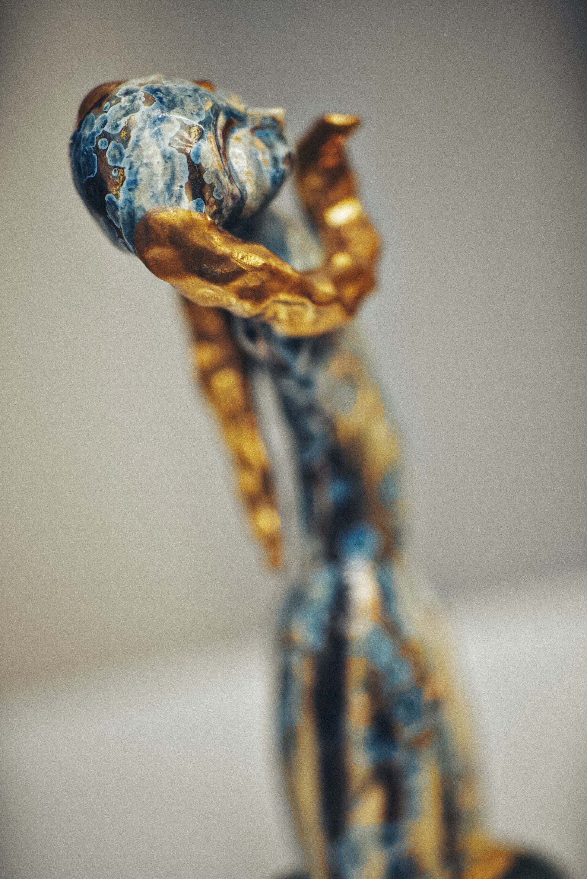 Decorative item with blue and gold design on a blurred background