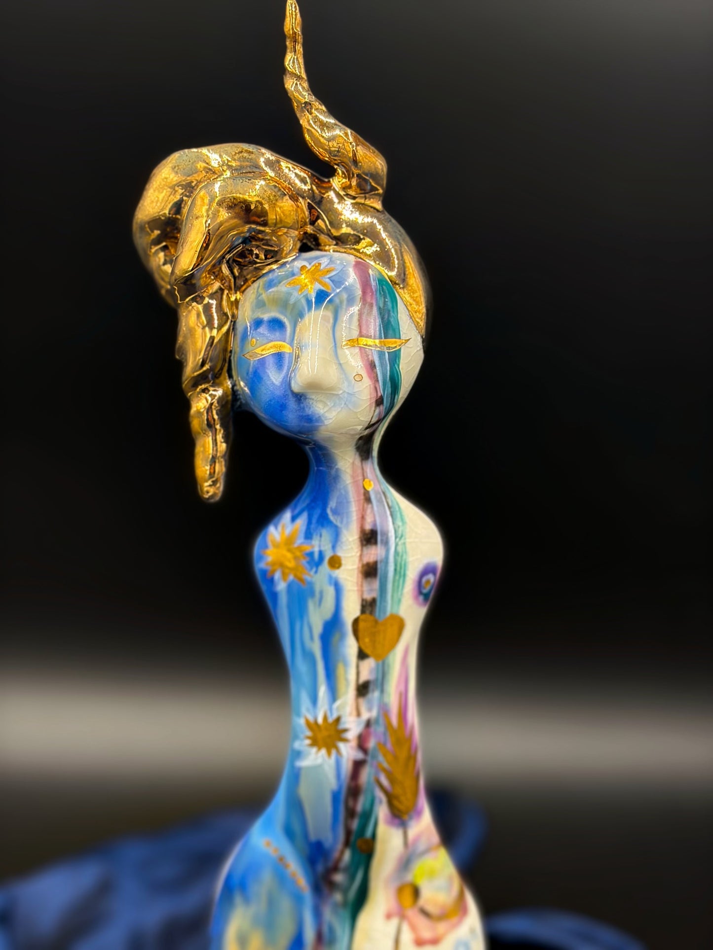 Decorative figurine with a gold on a black background