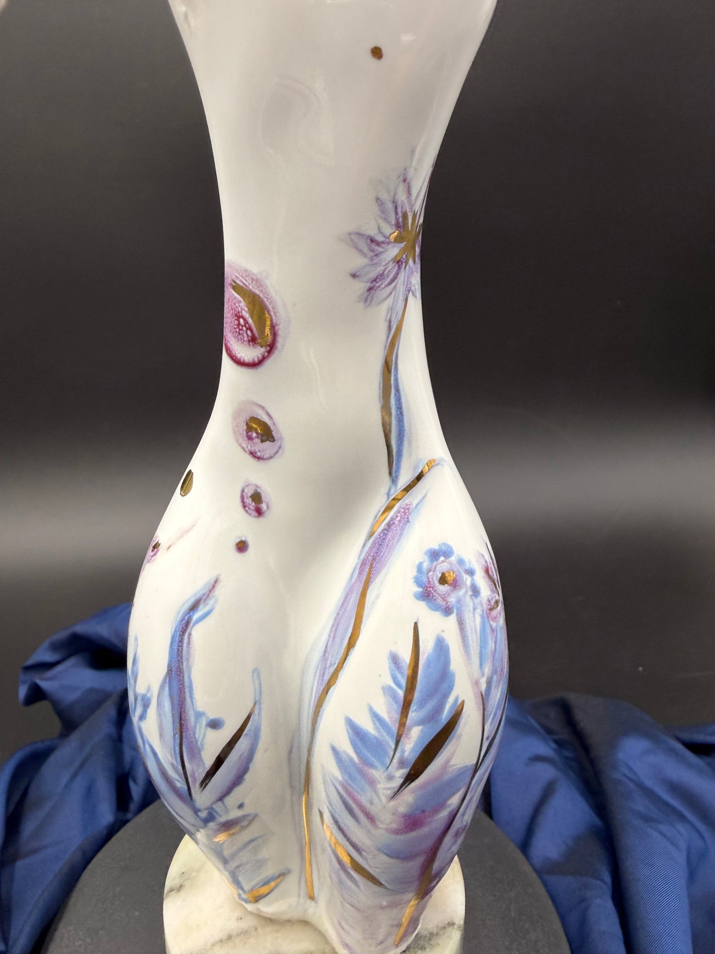sculpture with floral patterns against a dark background
