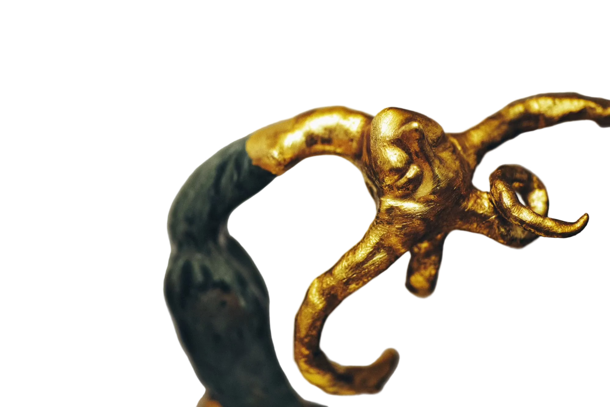 Gold and green decorative object on a gray background